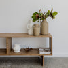 a collection of small terracotta vases on wood shelving  from corcovado homewares new zealand