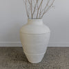 This large, rustic cream-painted terracotta pot from corcovado furniture and decor store new zealand
