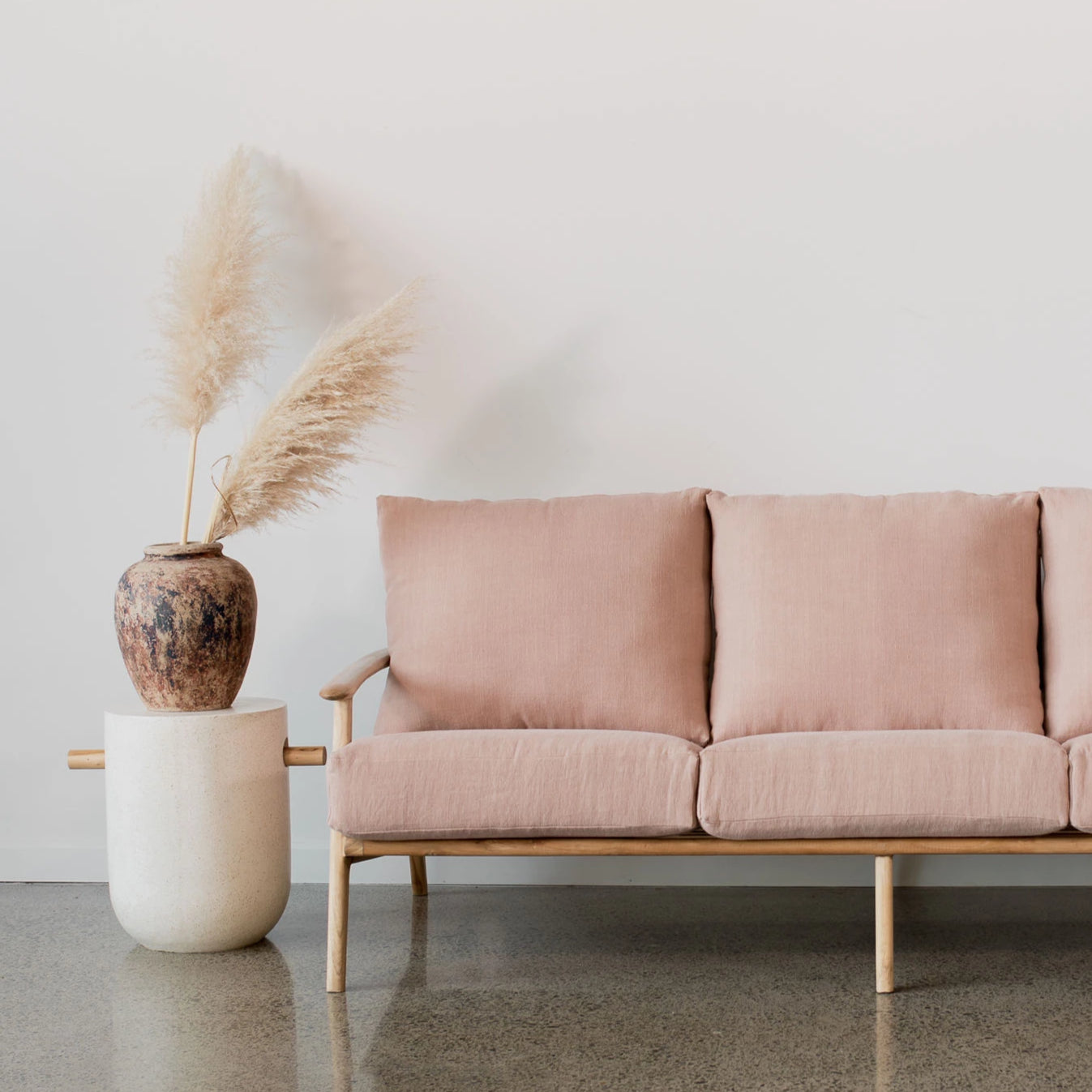 terrazzo white accent table and pink linen sofa from corcovado furniture store new zealand