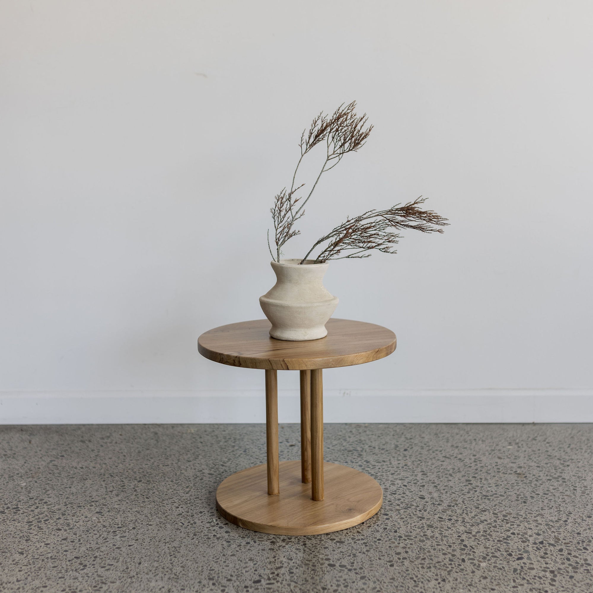 round disc wooden side table by corcovado furniture made from natural teak wood