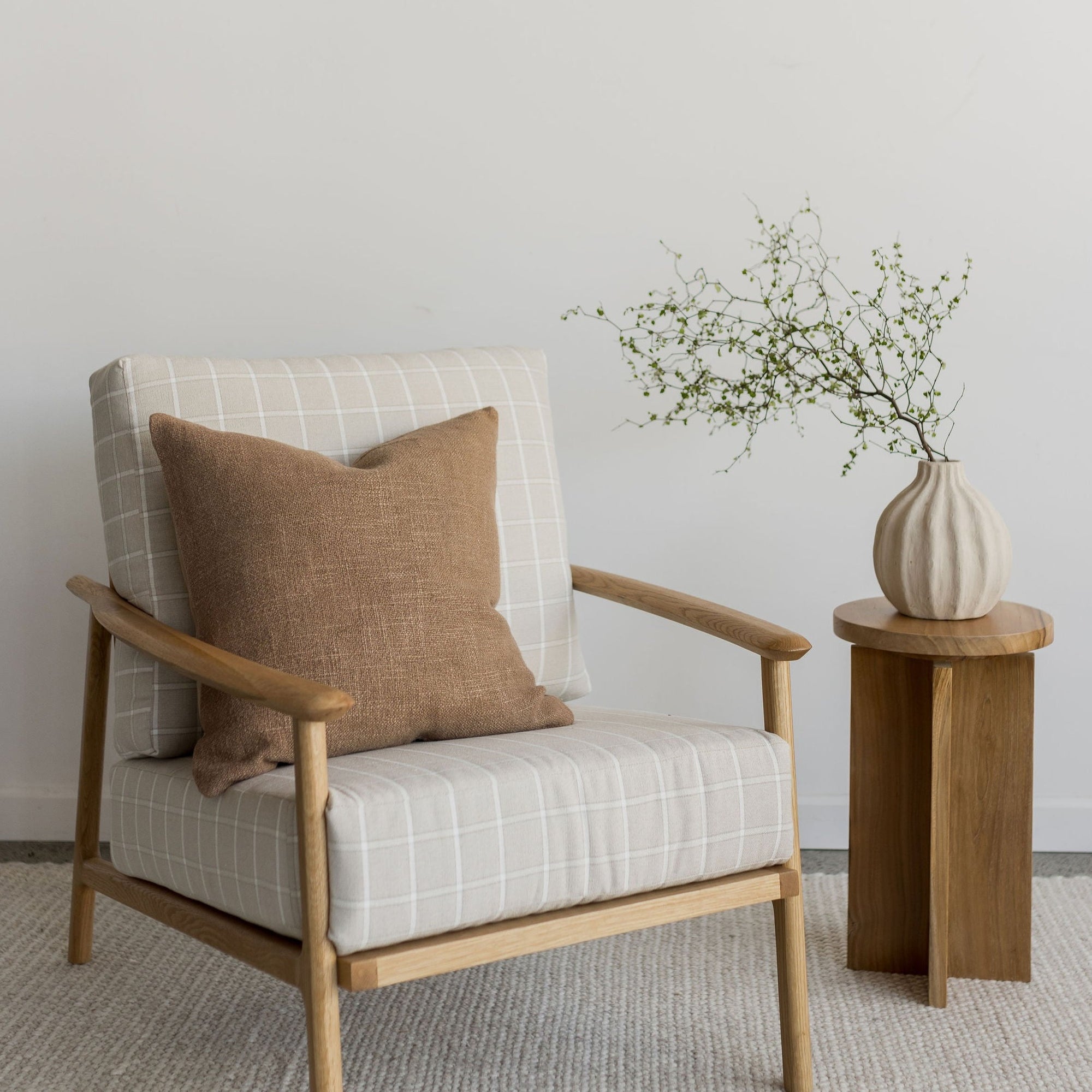accent arm chair and wooden side table with linen scatter cushion from corcovado furniture store new zealand