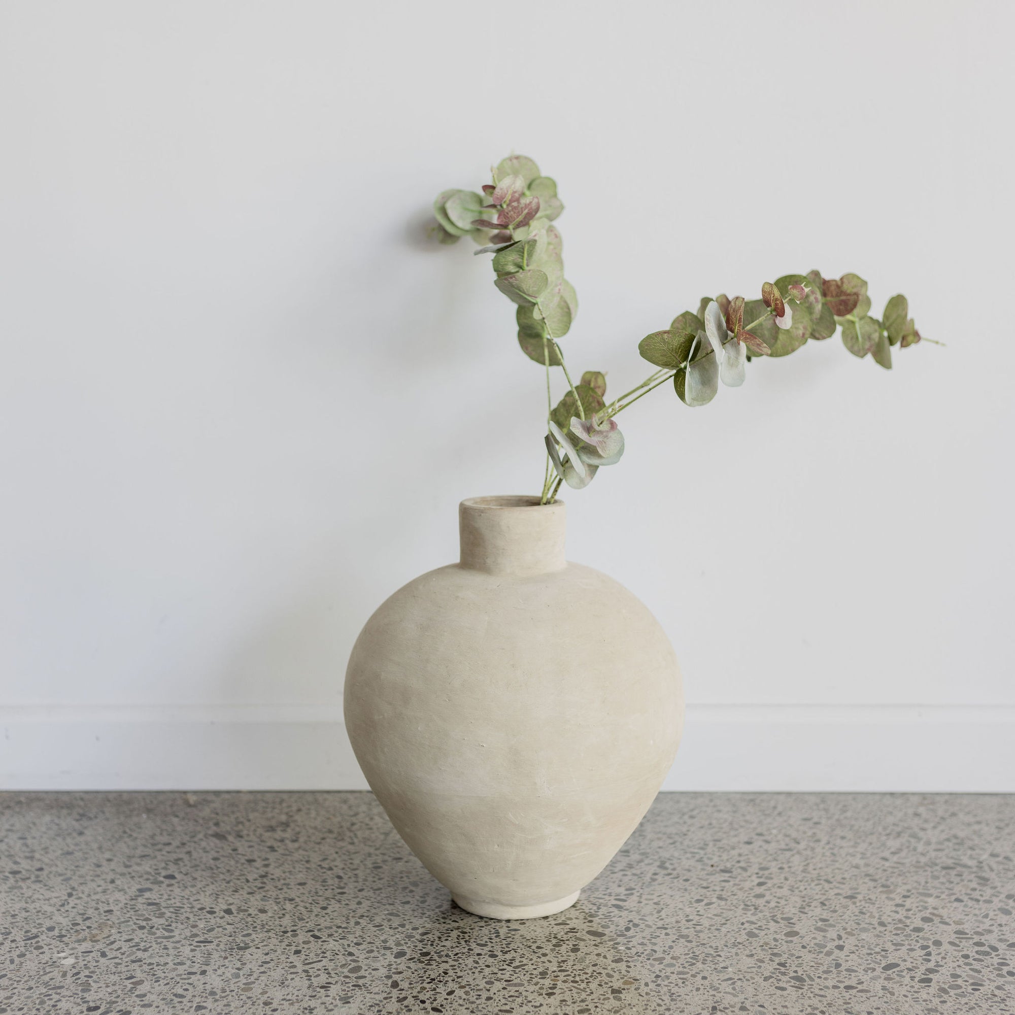 cream terracotta vase by corcovado with faux foliage gum leaves 