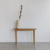 vase with harakeke flower and a modern wooden console entrance table by corcovado