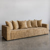 angled view of sunset 4 seater sofa made in new zealand by corcovado furniture store shown in gold velvet