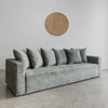angled view of sunset 4 seater sofa made in new zealand shown in jade green velvet