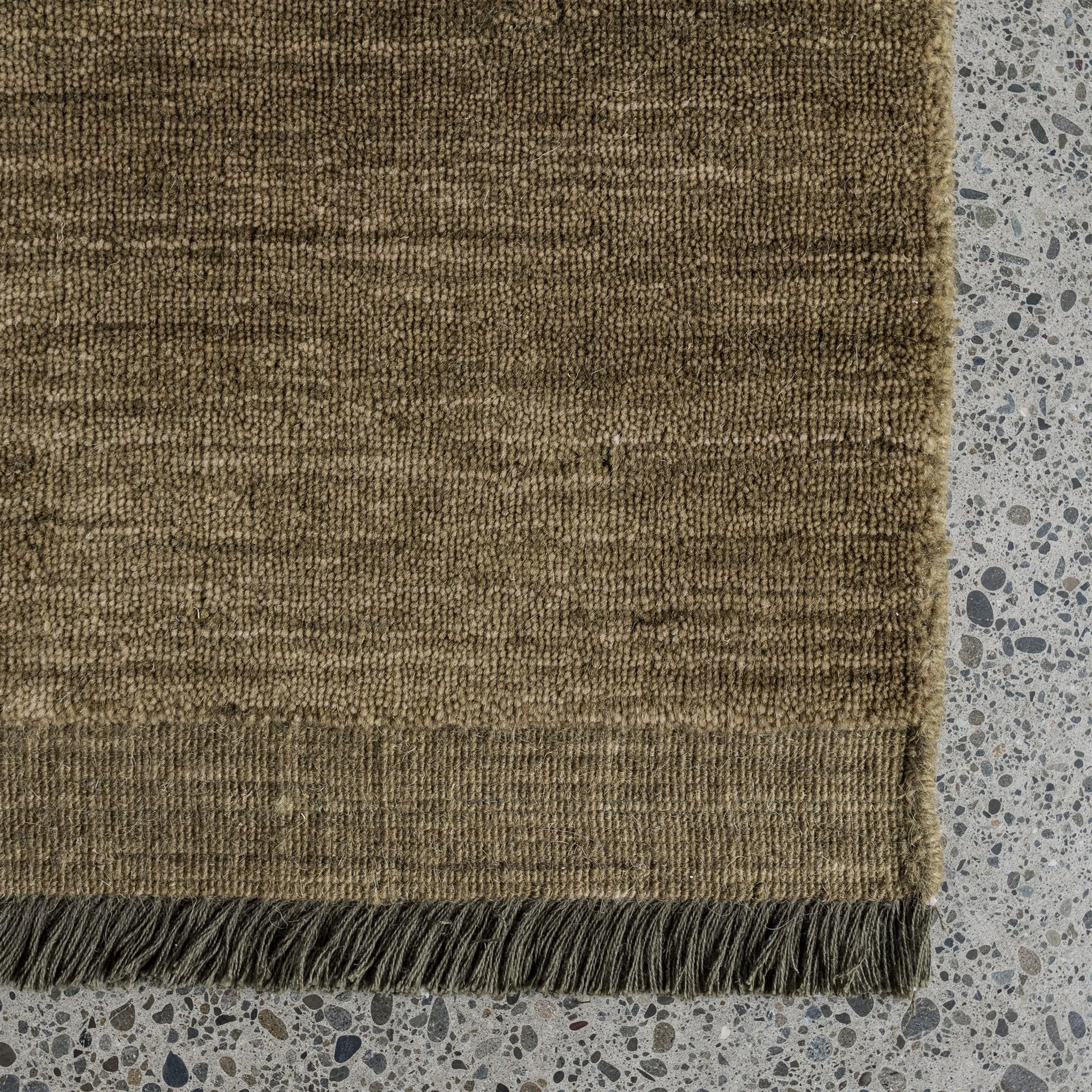 moss green floor rug detail with fringe by corcovado