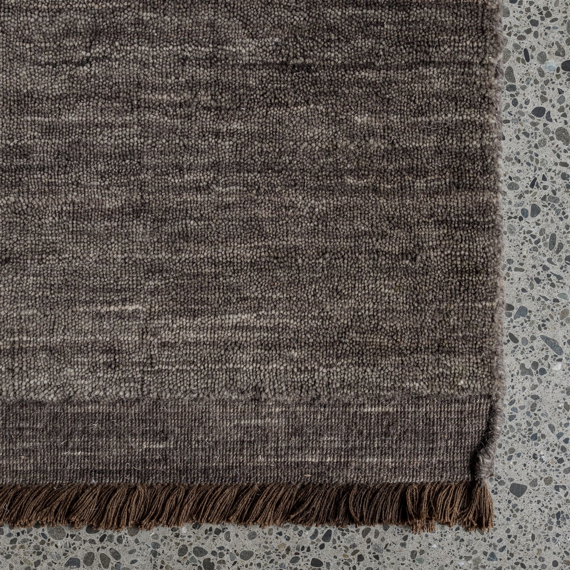 This contemporary rug is soft underfoot and rich in texture. It is finished with a sophisticated micro fringe, as shown.