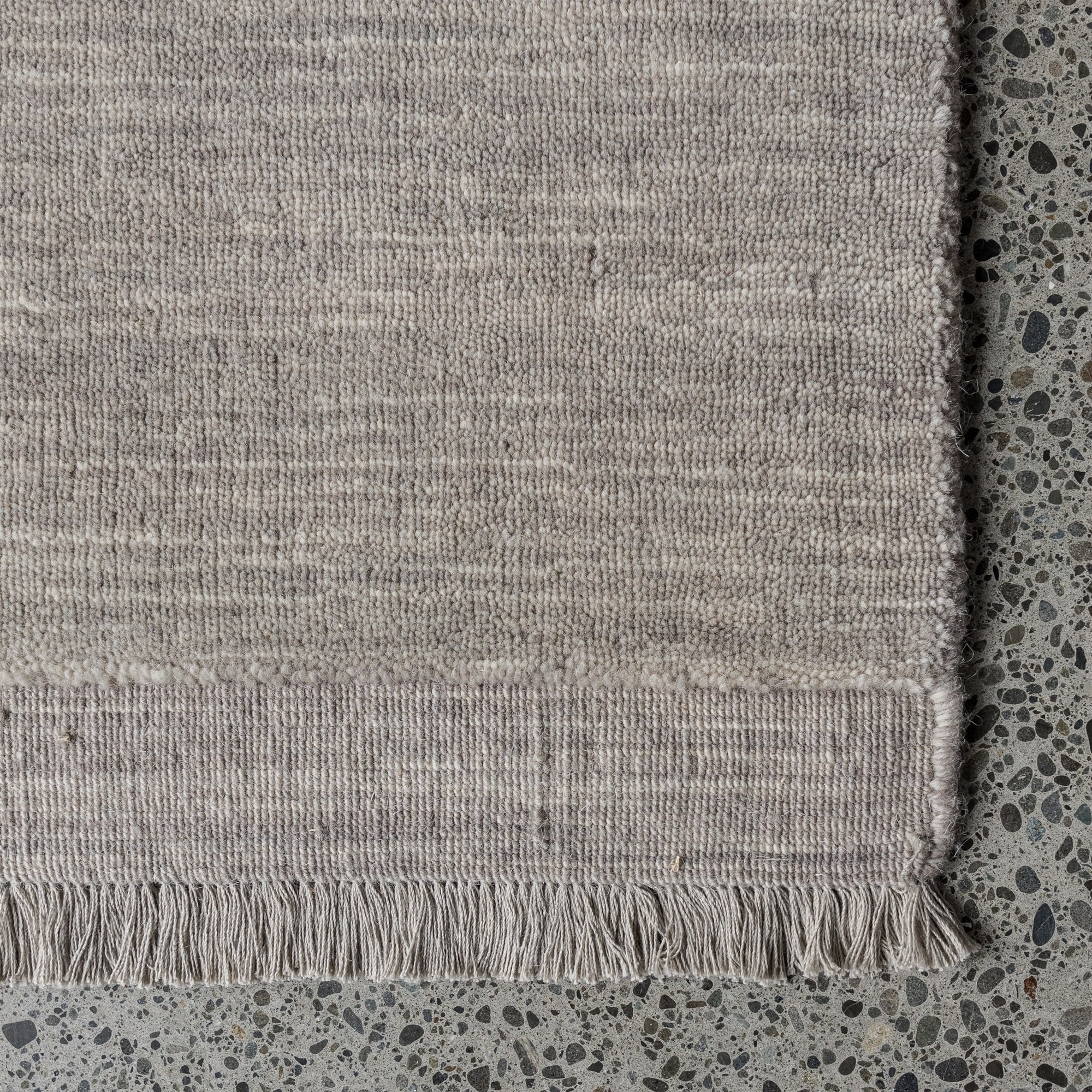 light grey rug with fringe detail from corcovado 
