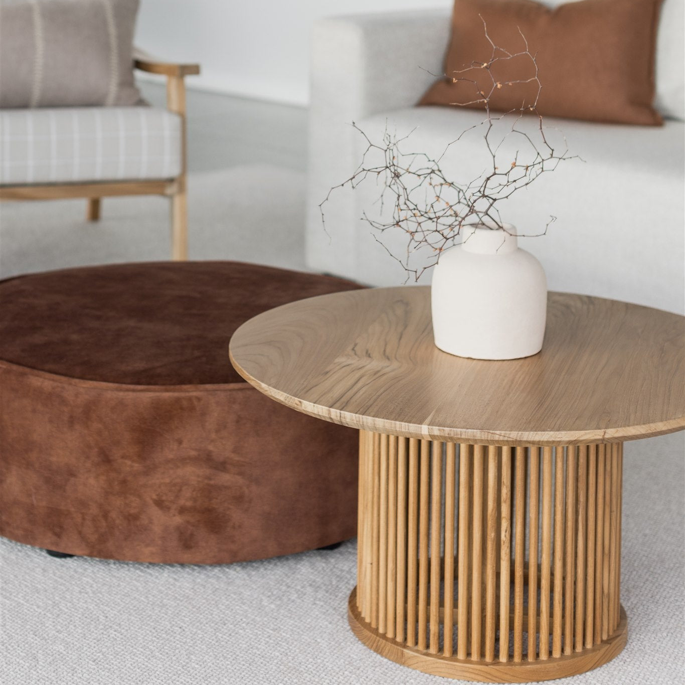 velvet ottoman with a round teak wood spindle coffee table by corcovado