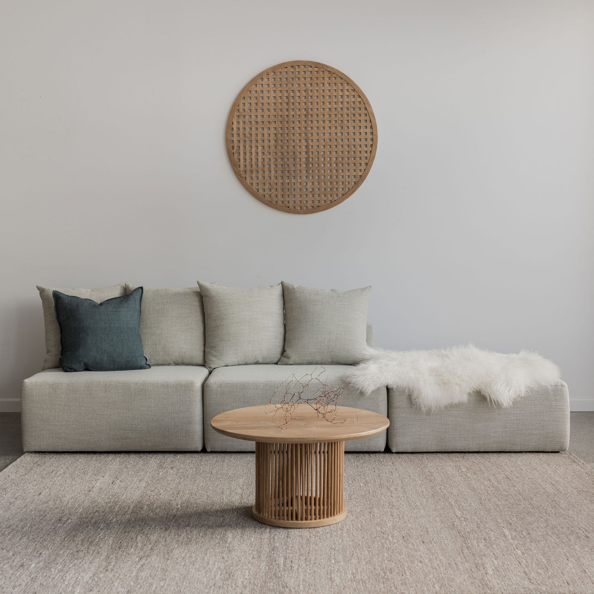 wooden wall art from Corcovado furniture store online nz modular sofa and ottoman chaise with white icelandic sheepskin and wooden round coffee table