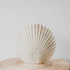 A ceramic vase that echoes art deco style in the form of a fan or peacock, in a soft creamy, off white shade from corcovado furniture and homewares