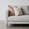 close up of the grey drift sofa with pink and cream cushions from corcovado