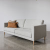 wide angled view of the corcovado sofa with tobacco cushion and wooden legs